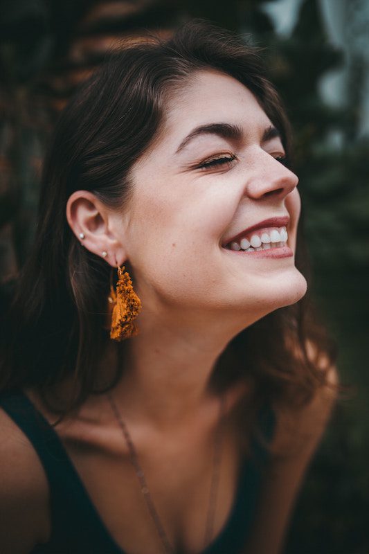 Young dark haired woman smiling.