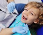 smiling child in dentist's chair